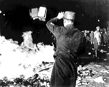 A Nazi-officer burning Jewish books in Berlin. 