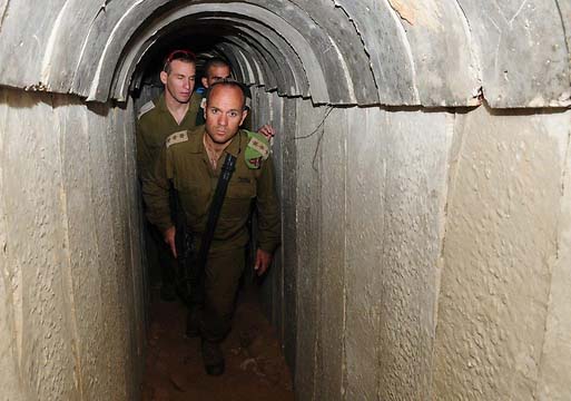 Israeli officers walk in the discovered tunnel of terror. 