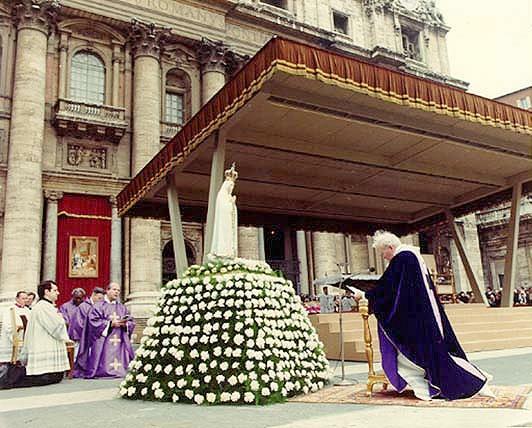 The Pope of Rome bowing down before a statue of the Catholic lady of Fatima