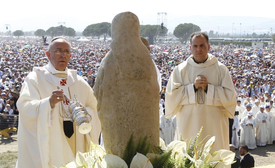 A large crowed watch the Pope worship a stone in Southern Italy. 